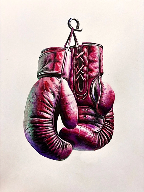 A pair of worn, red boxing gloves are laced up and hanging on a hook against a plain white background.